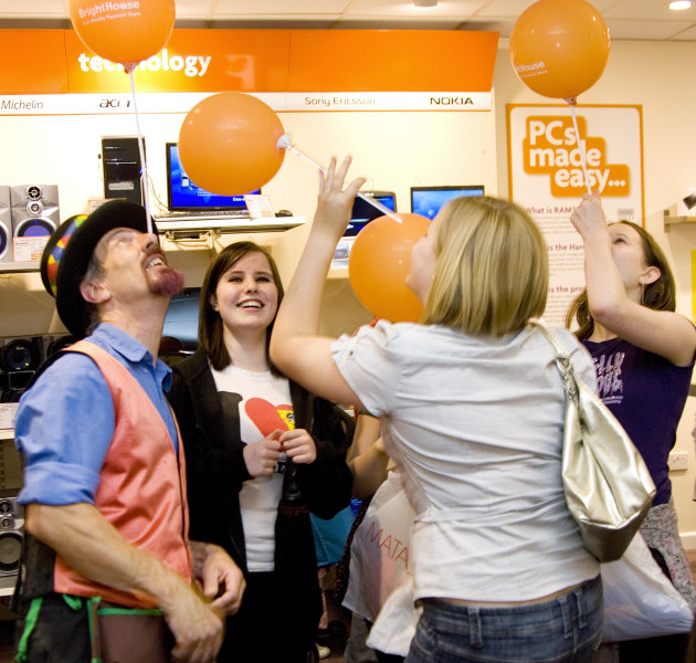 Kris Katchit teaches teenagers to balance a balloon on the nose