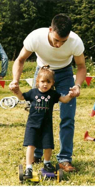 Dad helps daughter on the pedal go