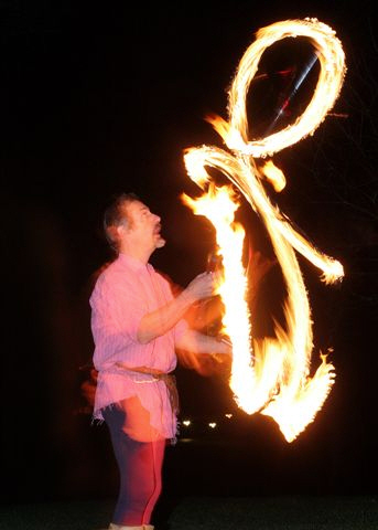 Kris Katchit juggles with fire torches
