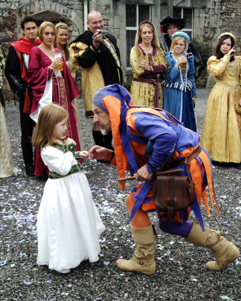 Kris Katchit entertains a child at a medieval wedding